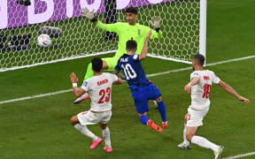 USA forward Christian Pulisic scores his team's first goal past Iran's goalkeeper Alireza Beiranvand during the Qatar 2022 World Cup Group B football match between Iran and USA at the Al-Thumama Stadium in Doha on 29 November, 2022.