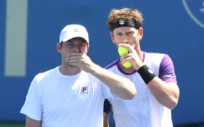 Michael Venus (right) of New Zealand talks with Neal Skupski of Great Britain during a doubles final match against Raven Klaasen of Brazil and Ben McLachlan of Japan on Day 9 during the Citi Open at Rock Creek Tennis Center on August 8, 2021 in Washington, DC.