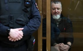 Igor Girkin (Strelkov), the former top military commander of the self-proclaimed "Donetsk People's Republic" and nationalist blogger charged with extremism, sits inside a glass defendants' cage ahead of his verdict hearing at the Moscow City Court in Moscow on January 25, 2024. (Photo by NATALIA KOLESNIKOVA / AFP)
