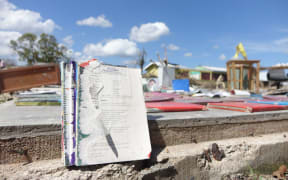 Library books drying on a concrete slab that used to be one of the classrooms of the Melemaat Primary School outside of Vila.