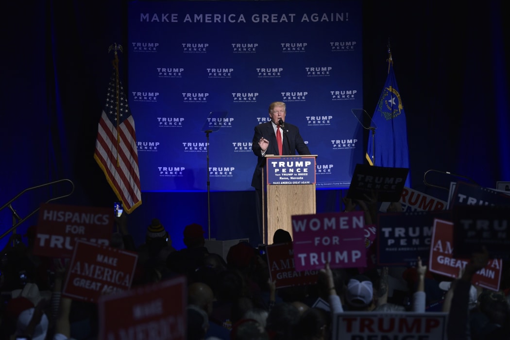 Donald Trump speaks upon his return after being escorted away when a protestor approached the stage.