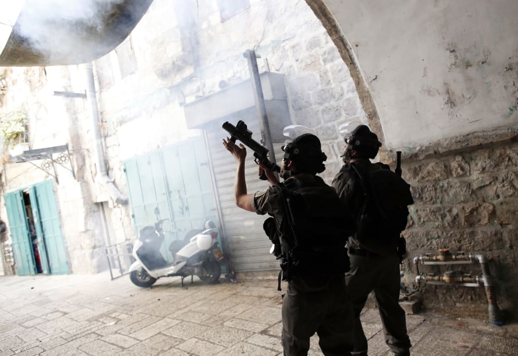 A picture taken on September 15 shows Israeli police using stun grenades to disperse Palestinian demonstraters in al-Wad street in the Muslim quarter of Jerusalem's Old City.
