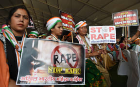 Supporters of President of the Indian National Congress Party Rahul Gandhi hold placards in reaction to the recent rape cases in India during a rally dubbed Jan Aakrosh Rally (public outrage), in New Delhi
