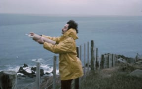 Dave Lowe taking an air flask sample at the edge of the Baring Head cliff in 1972.