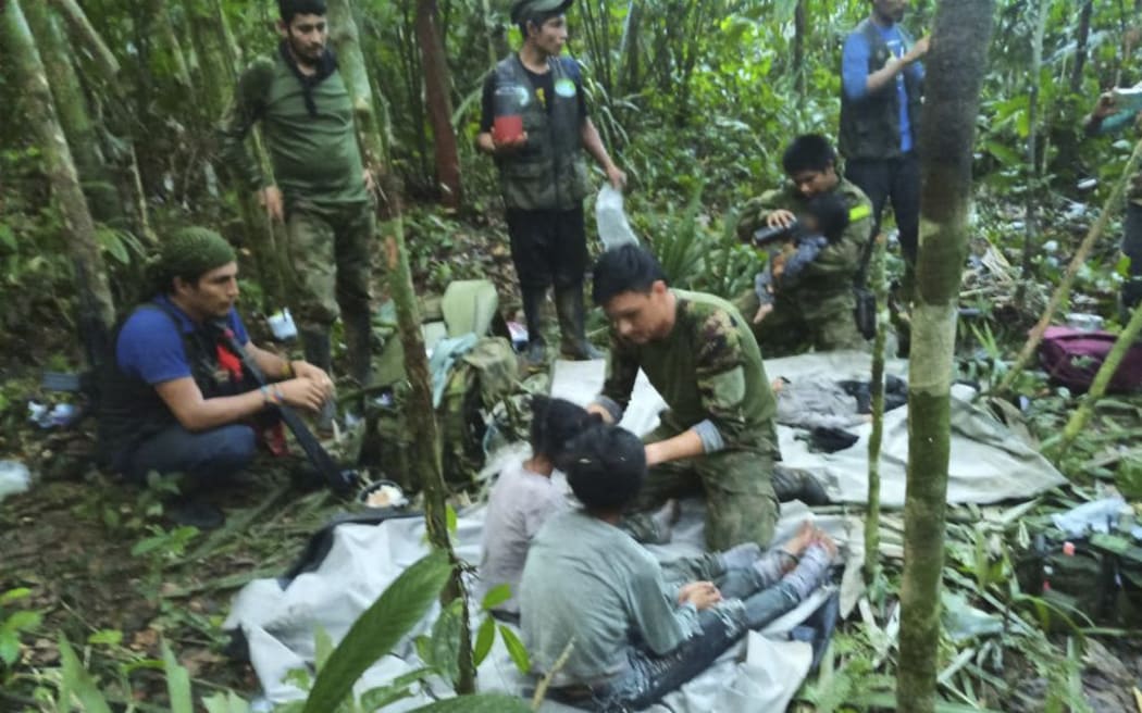 In this handout photo released on June 9, 2023, by the Colombian Presidency, members of the army attend to four Indigenous children who were found alive after spending more than a month lost in the Colombian Amazon jungle following the crash of a small plane. Four Indigenous children were found alive Friday after spending more than a month lost in the Colombian Amazon rainforest following a small plane crash that triggered a massive rescue operation, the country's President Gustavo Petro said. (Photo by Handout / Colombian Presidency / AFP) / RESTRICTED TO EDITORIAL USE - MANDATORY CREDIT "AFP PHOTO / Colombian Presidency" - NO MARKETING - NO ADVERTISING CAMPAIGNS - DISTRIBUTED AS A SERVICE TO CLIENTS