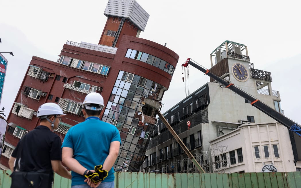 Heavy equipment are being used to demolish the Uranus building, which was damaged in the April 3 earthquake, in Hualien on April 5, 2024. At least nine people were killed and more than 1,000 injured by a powerful earthquake in Taiwan that damaged dozens of buildings. (Photo by I-Hwa CHENG / AFP)