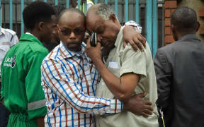 A man in the arms of a relative identifying the bodies of victims of the attack on DusitD2 luxury hotel complex in Nairobi, Kenya.