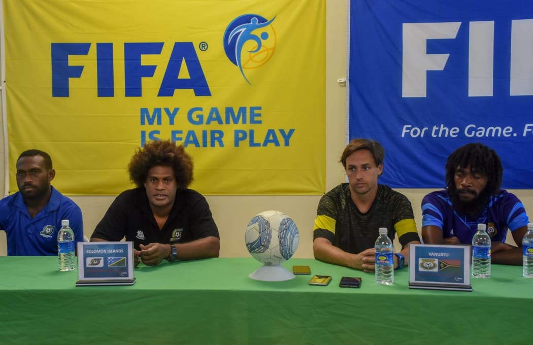 Captains and coaches from Solomon Islands and Vanuatu front the media.