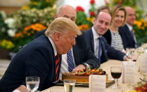 President Donald Trump blowing out a candle on his birthday cake.