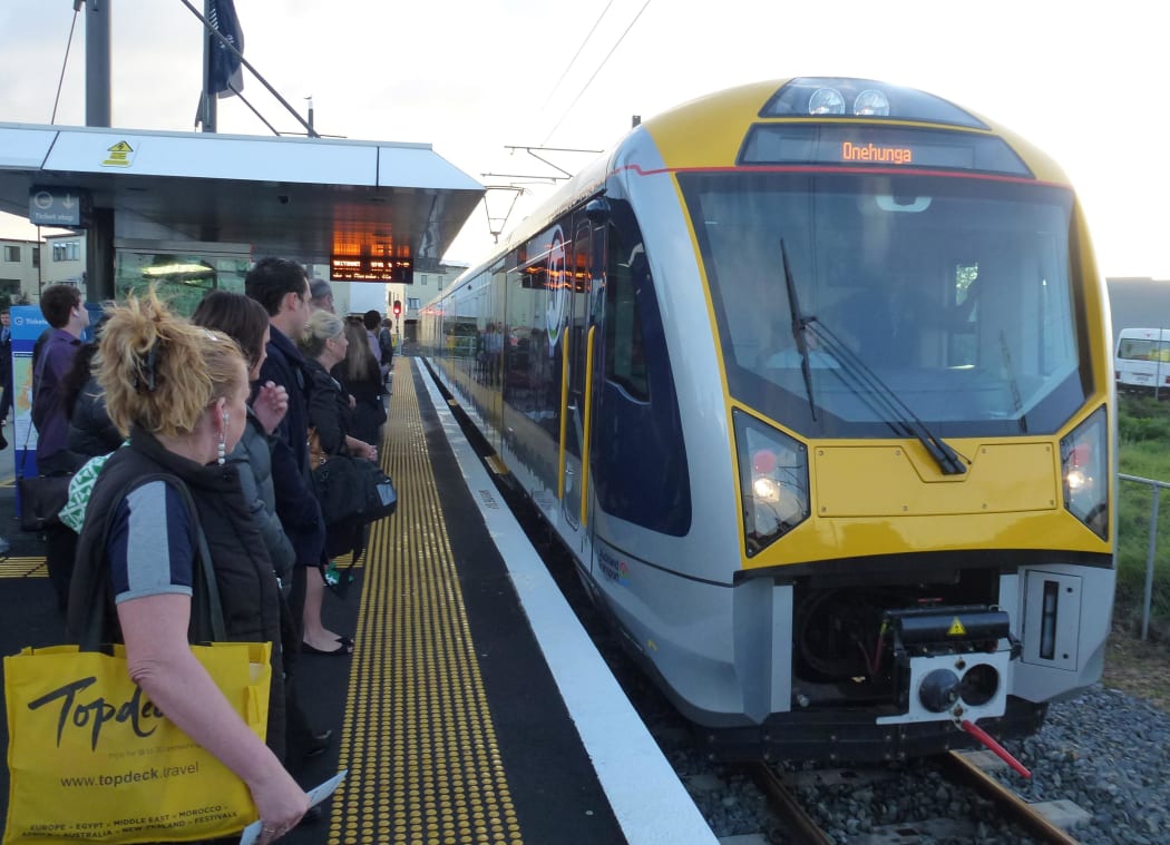 Commuters at Onehunga station as new electric trains start their regular runs.