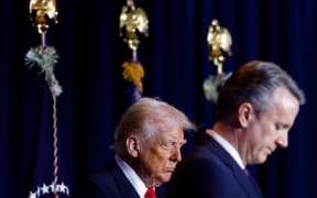 US President Donald Trump (L) bows his head during the National Prayer Breakfast at the Washington Hilton in Washington, DC, on February 6, 2025. (Photo by Ting Shen / AFP)