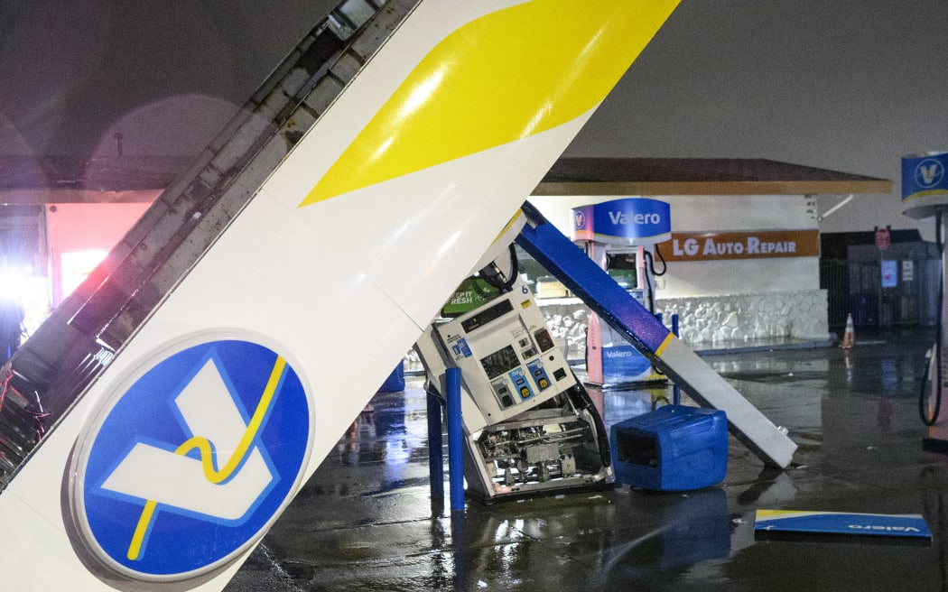 A damaged Valero gas station creaks in the wind during a massive "bomb cyclone" rain storm in South San Francisco, California on January 5.