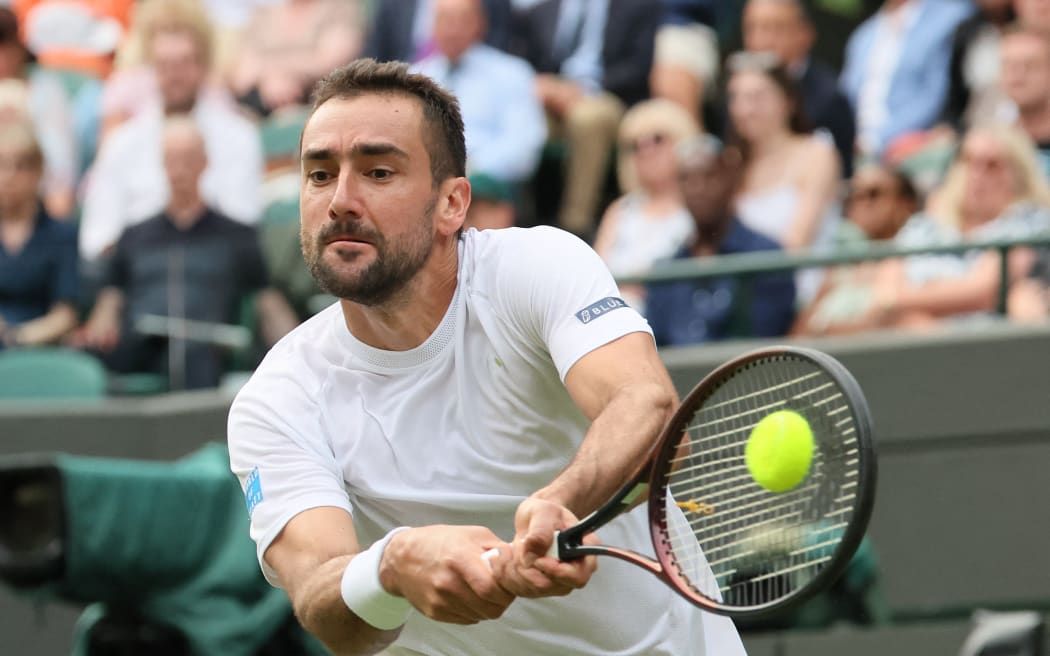 Marin Cilic of Croatia returns the ball to Jack Draper of the United Kingdom during the men's singles second-round match on day four of the Wimbledon Championships at the All England Lawn Tennis and Croquet Club in London, on Thursday, July 3, 2025. ( The Yomiuri Shimbun ) (Photo by Daisuke Urakami / The Yomiuri Shimbun via AFP)