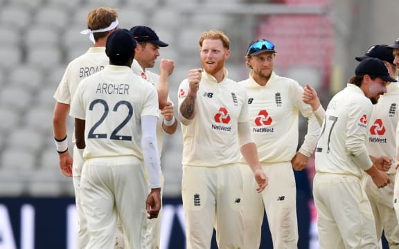 England's Ben Stokes (C) celebrates with teammates after taking the wicket of Pakistan's Shaheen Afridi on the third day of the first Test cricket match between England and Pakistan at Old Trafford in Manchester, north-west England on August 7, 2020.