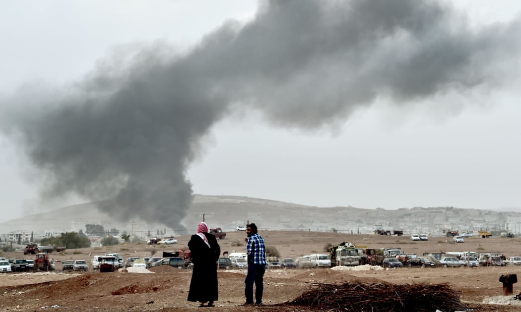 Smoke rises from the Syrian town of Kobane after air strikes yesterday.