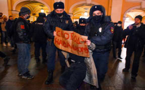 Police officers detain a supporter of Russian opposition leader Alexei Navalny in Saint Petersburg.