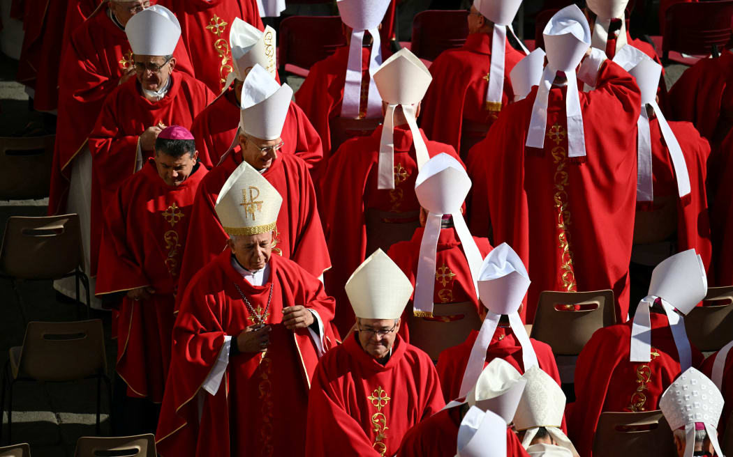 Cardinals walk to take their places ahead of the late Pope Francis' funeral ceremony at St Peter's Square at The Vatican on April 26, 2025. (Photo by Mandel NGAN / AFP)