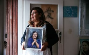 Auckland councillor Josephine Bartley with a picture of her mother Ruth, who she says had a chronic gambling problem, which led to her eventually losing the family home in Māngere.