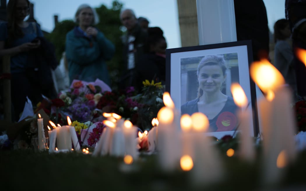 Candles are lit around floral tributes in Parliament Square central London in remembrance of Labour MP Jo Cox.