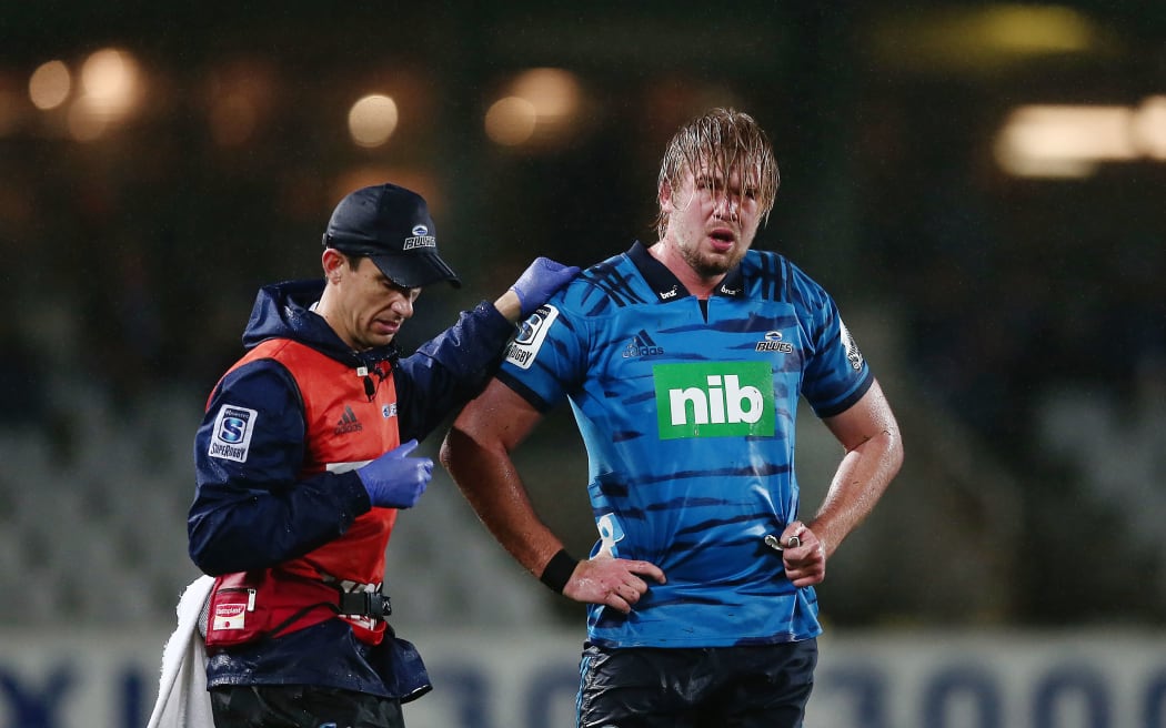 Josh Goohue of the Blues is escorted off the field for a concussion test.