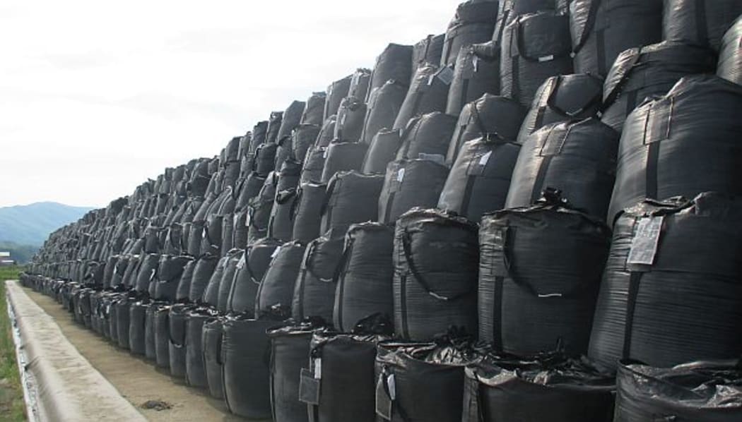 Huge black storage bags piled more than six high stretch as away as far an the eye can see.