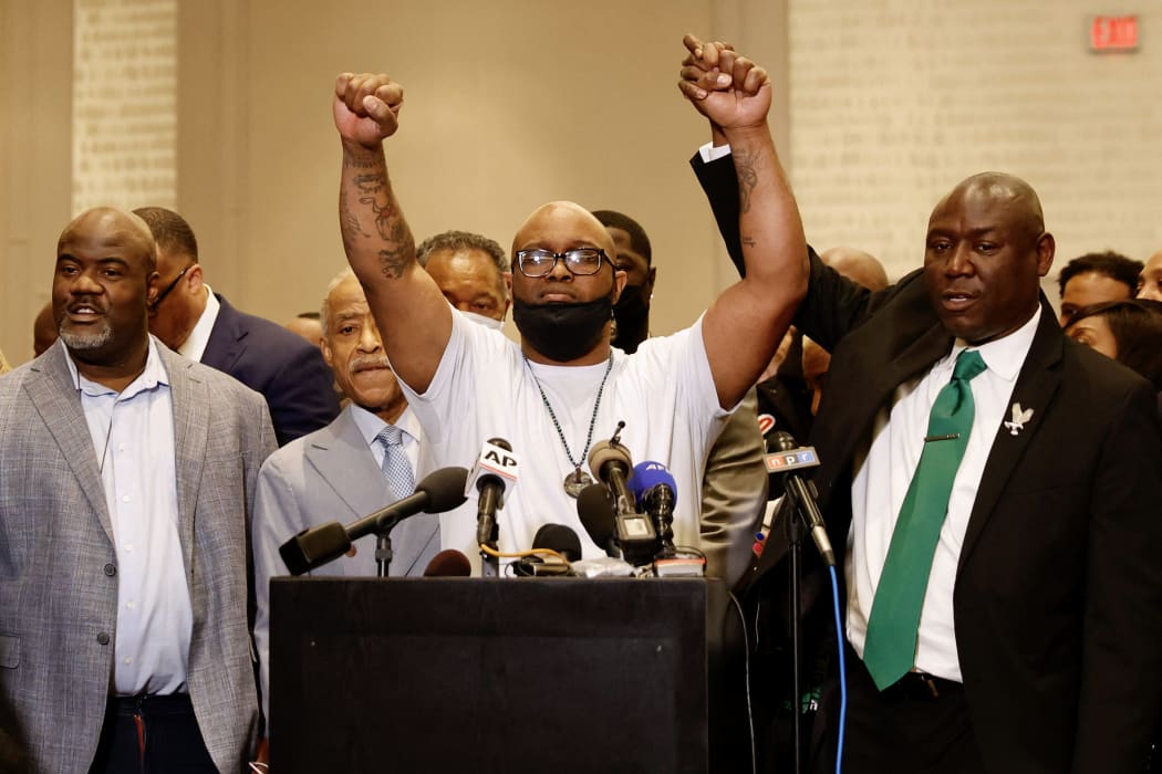 George Floyd's brother Terrence Floyd, centre, holds up his hands with family lawyer Ben Crump, right.following the verdict in the trial of former police officer Derek Chauvin in Minneapolis, Minnesota.