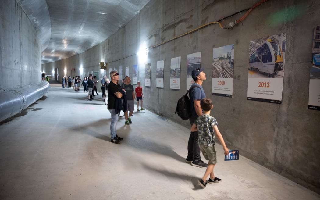 A concrete tunnel with a lot of people in it.