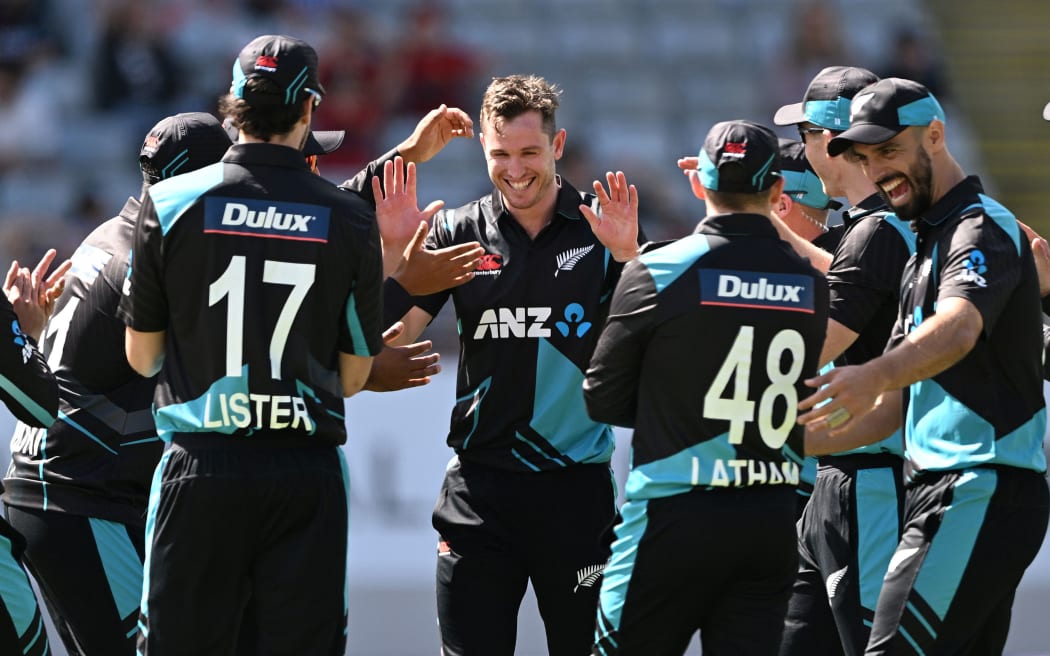 Adam Milne and team mates celebrate a wicket.