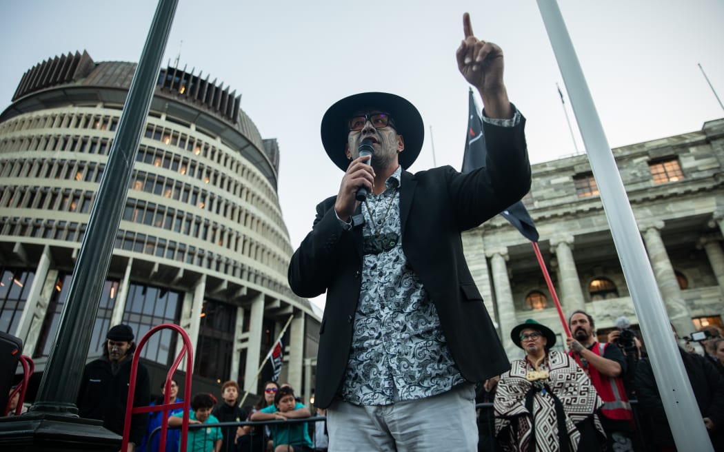 Te Pāti Māori co-leader Rawiri Waititi speaks to protesters outside of Parliament.