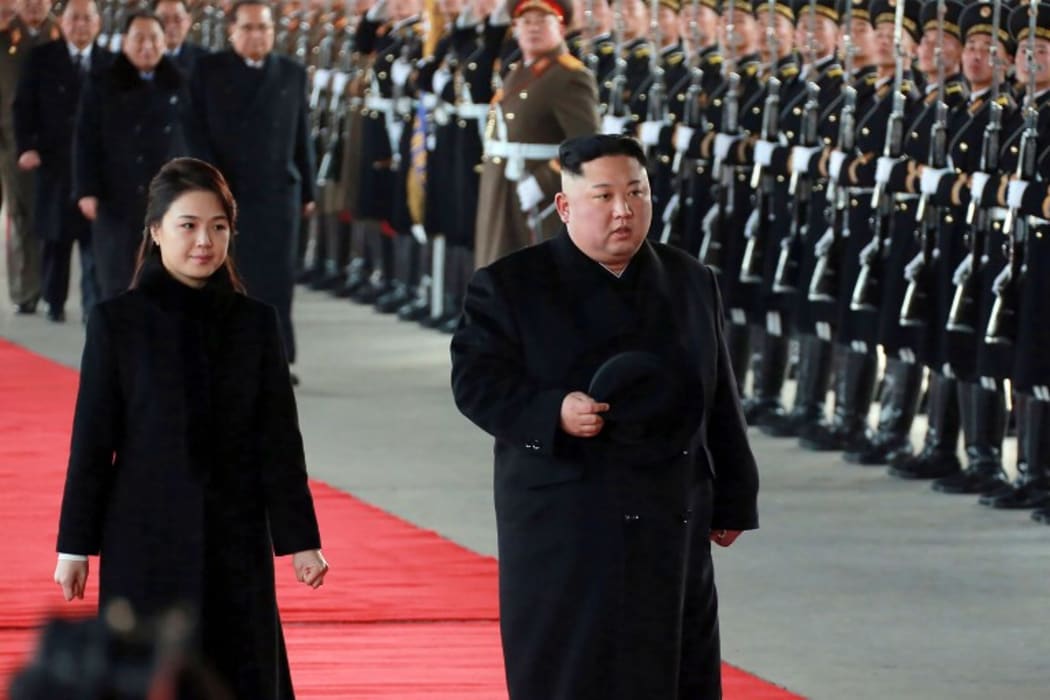 This picture taken on January 7, 2019 and released by North Korea's official Korean Central News Agency (KCNA) on January 8, 2019 shows North Korean leader Kim Jong Un (R) and his wife Ri Sol Ju leaving Pyongyang Station to visit China.  AFP.