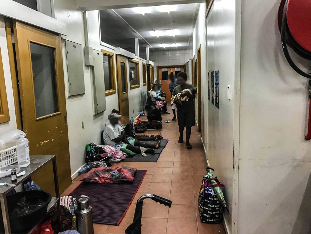 Patients wait along a corridor in the triage area of the National Referral Hospital in Solomon Islands.