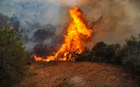 A handout picture released by the official Syrian Arab News Agency (SANA) on October 10, 2020 shows a fire devouring a forest in Syria's Latakia province the previous day.