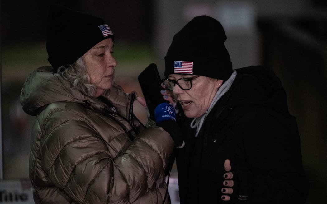 Micki Witthoeft (left), the mother of Ashli Babbitt who was killed on January 6, 2021 during the attack on the US Capitol, and Nicole Reffitt, the wife of Guy Reffitt who was jailed for the  January 6, 2021 attack on the US Capitol, speak with an inmate at a vigil for January 6th defendants outside the Washington DC Central Jail on 3 January, 2024.