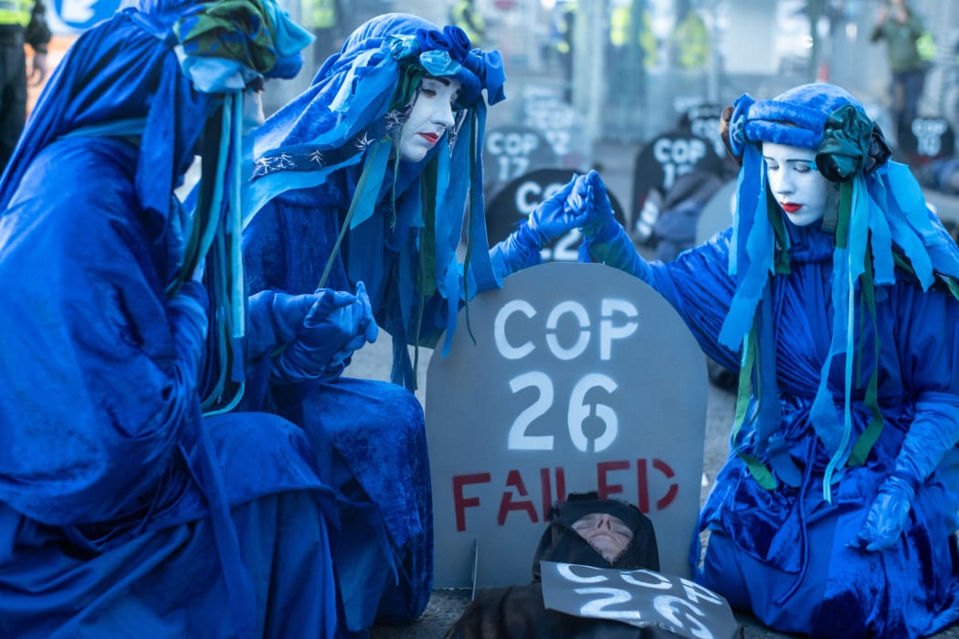 Extinction Rebellion members mourn what they called COP26's failure in Glasgow.