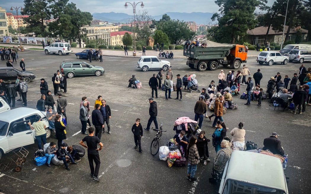 Ethnic Armenians wait to be evacuated from Stepanakert on 26 September, 2023. Armenia on September 26 said 28,120 refugees have so far arrived from Nagorno-Karabakh, a majority ethnic Armenian breakaway enclave defeated in a lightning offensive by Azerbaijan last week.