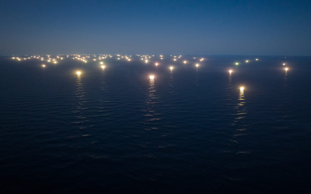 Chinese squid ships, which make up the largest distant water fleet in the world, fishing near the Falkland Islands.  The Chinese squid fleet uses bright lights to draw squid up from the depths.