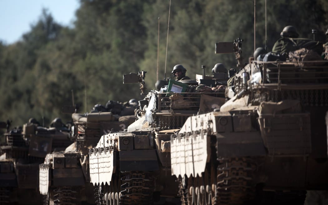 A convoy of Israeli Merkava tanks roll near Israel's border with the Gaza Strip on July 11.