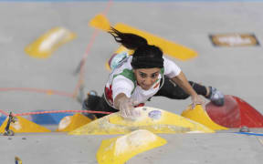 A handout picture provided by the International Federation of Sport Climbing (IFSC) shows Iranian climber Elnaz Rekabi competing during the women boulder finals of the Asian Championships of the IFSC in Seoul, South Korea.