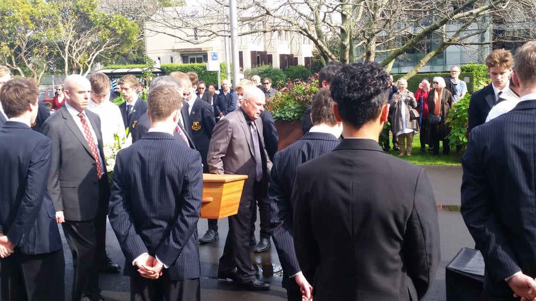 Mourners carry Sir John Graham's coffin at his funeral in Auckland.