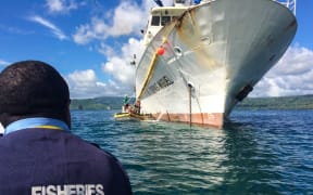 A Papua New Guinea fisheries officer prepares to board a fishing vessel for inspection in Rabaul.