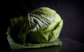 Whole cabbage on a black background