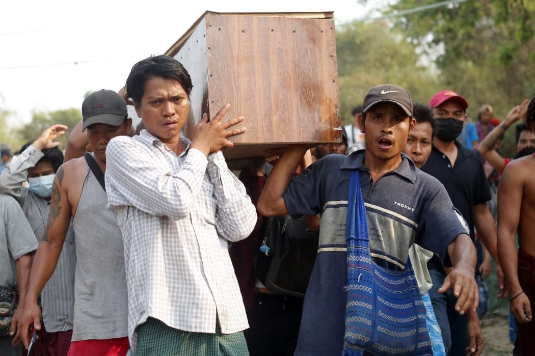 Mourners carry the coffin of Tin Hla, 43, who was shot dead by security forces during a protest against the military coup in Thanlyin township, outskirts of Yangon, Myanmar on March 27, 2021.