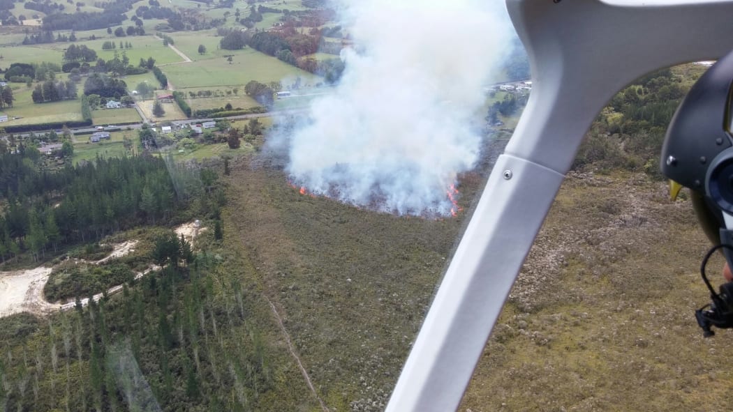 Ten homes were evacuated as fire raged through dry scrub near a pine forest just west of Ngawha in Northland on 13 December 2015.