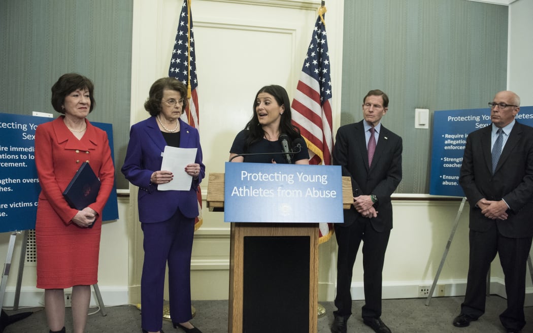Senator Susan M. Collins(L) (R-ME), Senator Dianne Feinstein(2ndL) D-CA, Senator Richard Blumenthal (D-CT) and Rick Adams (R), a representative of the US Olympic Committee, listen while Dominique Moceanu, 1996 Olympic gold medalist, speaks during a press conference on Capitol Hill about a bill meant to combat sexual abuse of young athletes March 28, 2017 in Washington,DC. (Photo by Brendan Smialowski / AFP)
