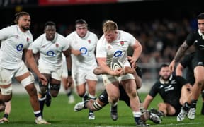 England prop Fin Baxter is tackled against the All Blacks during the first test in Dunedin.