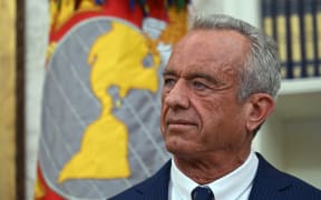 Robert F. Kennedy Jr., listens to US President Donald Trump before a swearing in ceremony for Kennedy as Secretary of Health and Human Services in the Oval Office of the White House in Washington, DC, on February 13, 2025. (Photo by ANDREW CABALLERO-REYNOLDS / AFP)
