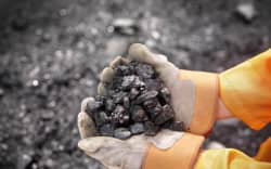 Coal Worker With Handful Of Coal (Photo by Monty Rakusen / Cultura Creative / Cultura Creative via AFP)