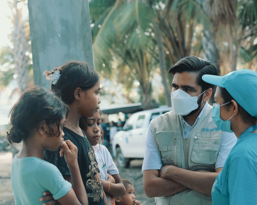 UNICEF's head in Dili, Bilal Durrani (second from right), meets locals.