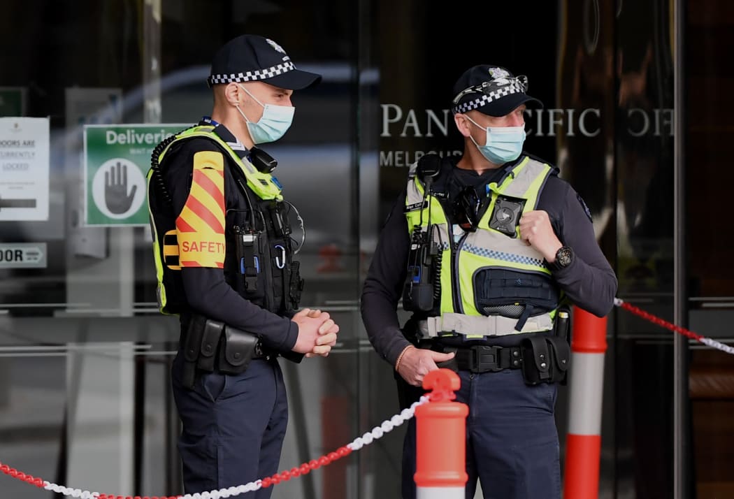 Police stand guard at a hotel in Melbourne in early December, where Australians returning from overseas will quarantine as part of precautions against Covid-19.