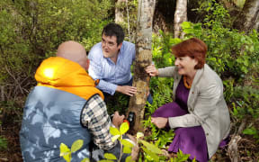 Goodnature founder Robbie van Dam, left, MP Chris Bishop and Maggie Barry check out a trap in the sanctuary.